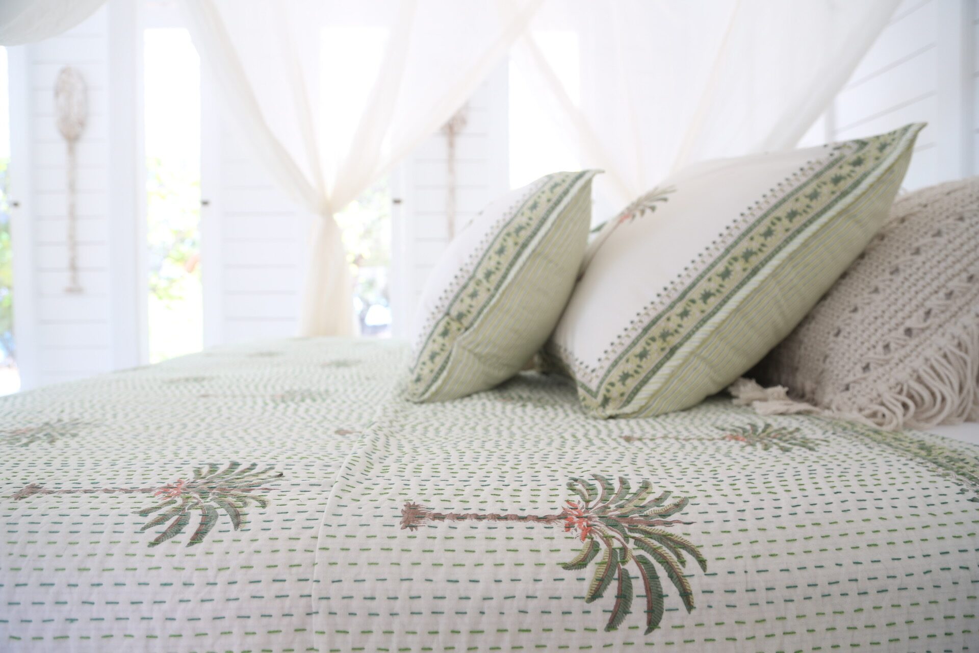Serene bedroom interior of the Beach House in soft morning light